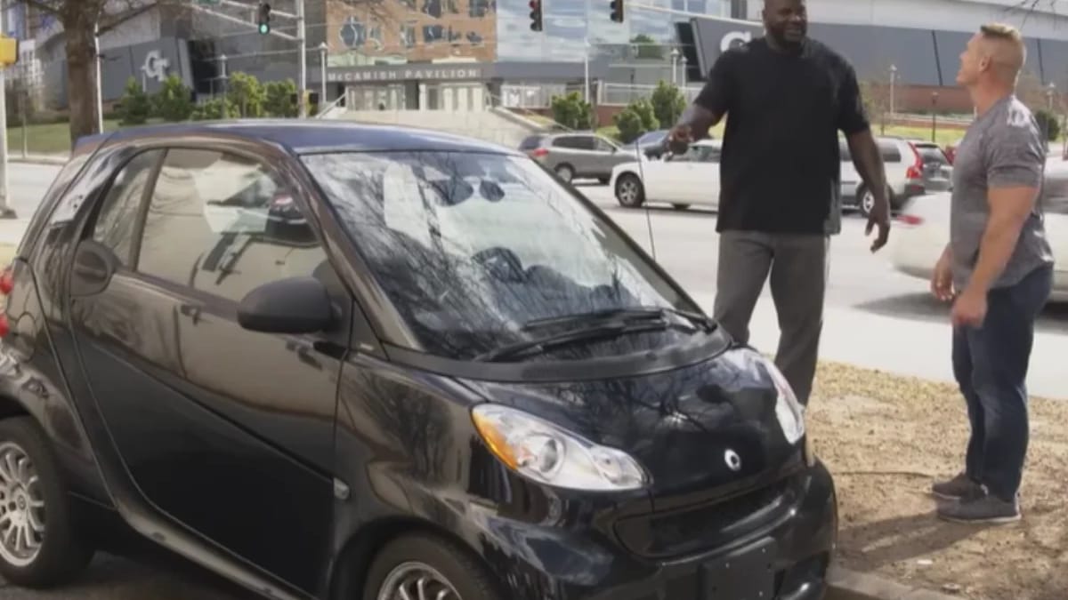 Shaq tries squeezing into a tiny Smart car with John Cena and it goes
