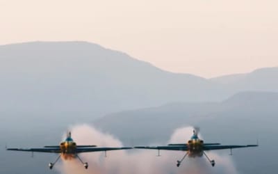 Two Red Bull planes fly through a hangar in one of the most jaw-dropping aviation stunts of all time