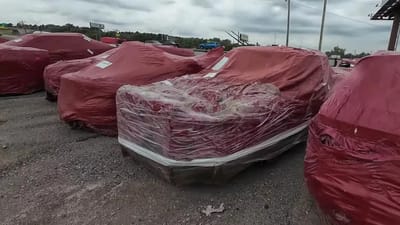 Oklahoma lot has hundreds of cars wrapped in red plastic bags hiding secrets and you get in big trouble if you remove them