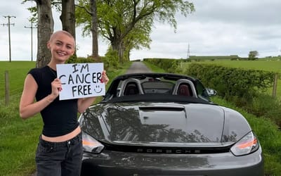 Woman celebrates beating cancer by driving into the sunset in her Porsche supercar