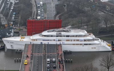 Kansas auto tycoon’s 270-foot $100m superyacht dwarfs homes as it inches beneath lifting bridge