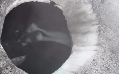 Alaskan helicopter pilot shows off freaky 'bottomless' holes in melting glaciers