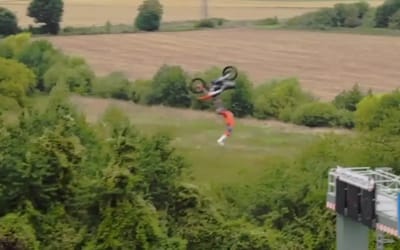 Red Bull motorcyclist achieves unreal backflip between two moving trucks