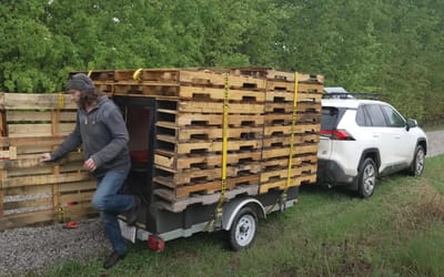 Trailer full of stacked, damp pallets is actually the stealthiest camper ever