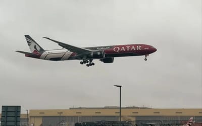 Qatar Airways Boeing 777's new F1 livery stands out in stormy conditions as it performs a dramatic landing