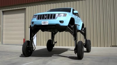 This Jeep Grand Cherokee SUV was modified so it could rise to nearly 9ft high and drive over traffic rather than sit in a jam