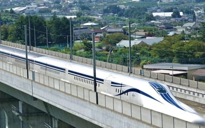 Breathtaking footage shows Japanese maglev train whizzing past at 310mph like a bullet while a crowd looks on stunned