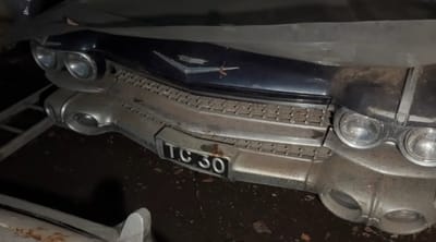 Man exploring abandoned farm finds incredible car collection left to rot, including Jaguar and Cadillac