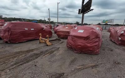 Many cars wrapped in red plastic bags were found in a yard in Oklahoma hiding secrets