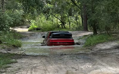 Rivian R1T serves as a boat on a heavily flooded road and its warranty remains valid
