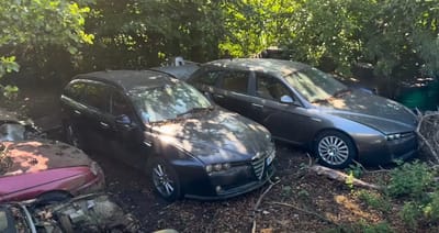 Old abandoned car dealership is now a huge car graveyard full of Alfa Romeos due to a tragic story
