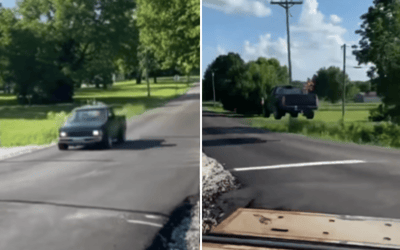 Little Nissan truck gets huge amount of air when it hits jump over train line