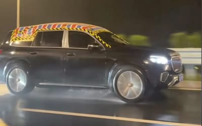 Driver covered luxury Maybach with tarp to stop water leak and inspired trend