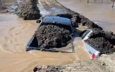 California farmers sacrifice their pickup trucks to stop water from flooding their crops