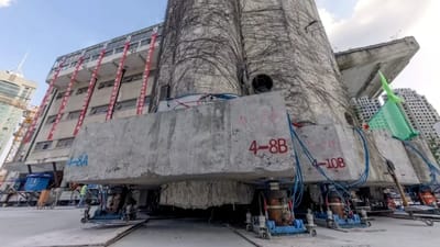 An 85-year-old, 7,600-tonne building is relocated 203ft in China using 198 robotic legs