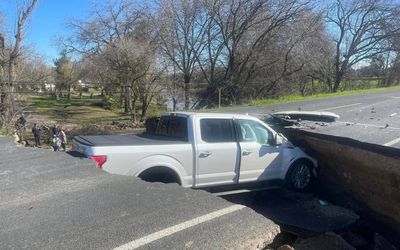 ‘We can’t make this stuff up’: Drivers ignore warning signs and drive straight into a SINKHOLE