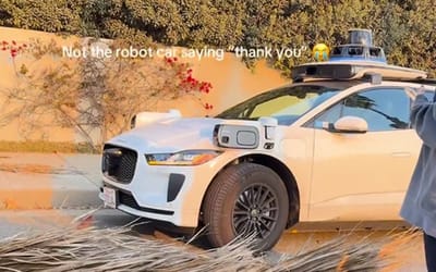 Waymo car personally thanks humans after they clear an obstruction from the road