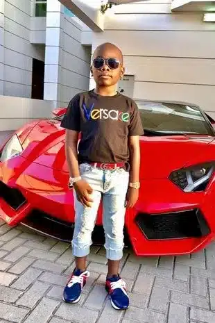 The 'world's youngest millionaire' loves posing in front of his supercar fleet