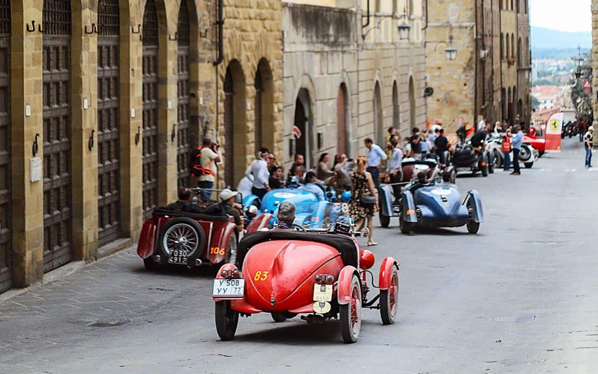 Cars drive away during the 1000 Miglia.