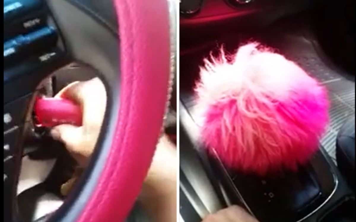 A pink car key in the ignition on the left and a pink fuzzy accessory on the gear shift on the right.