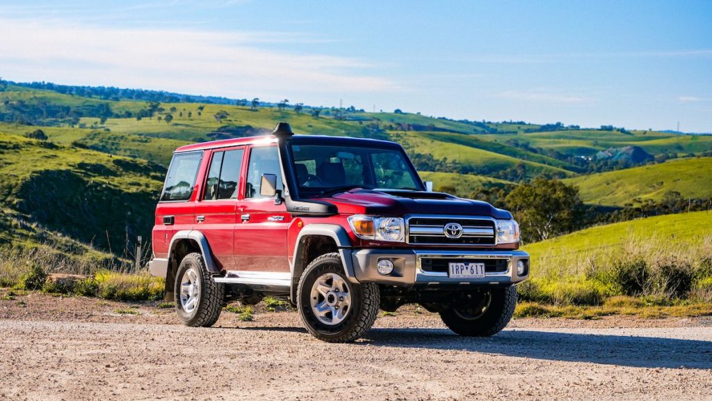 The Toyota LandCruiser 70 Series in front of rolling hills
