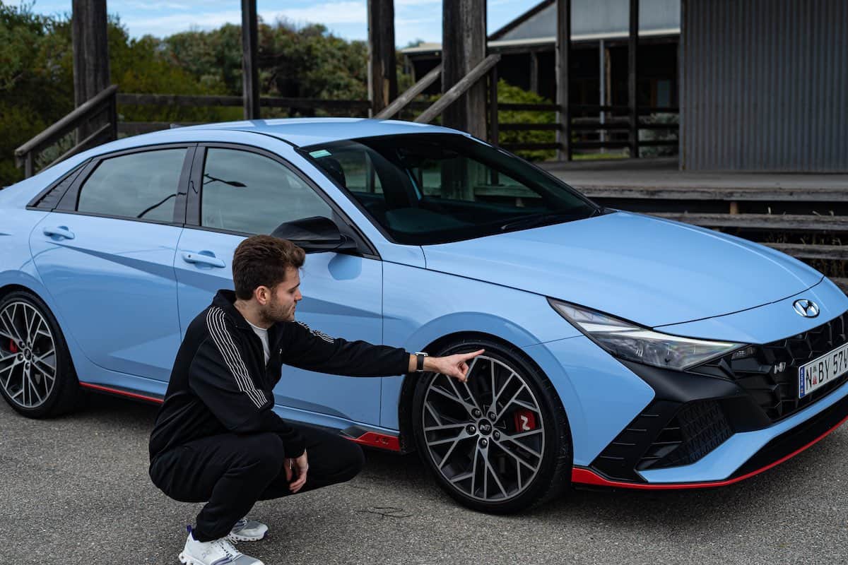 Patrick Jackson pointing at the special Michelin tires on the 2022 Hyundai Elantra N