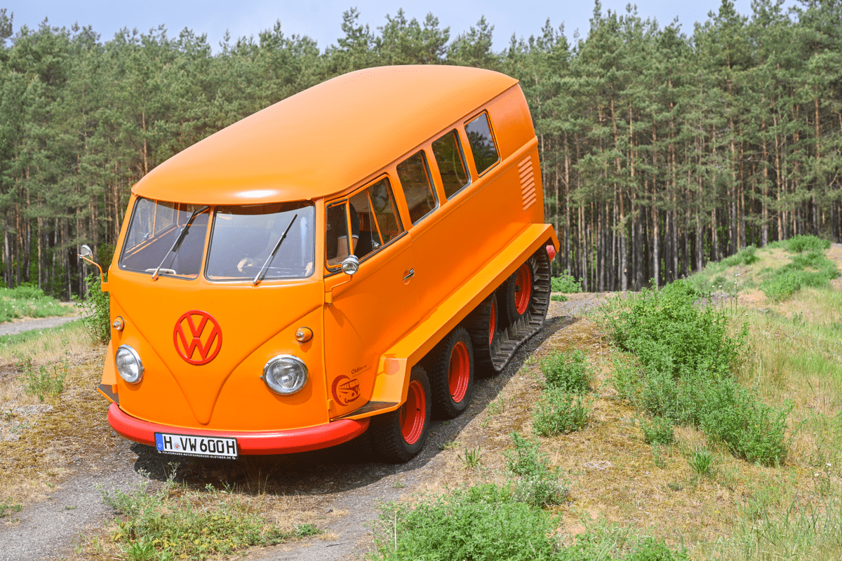 VW kombi campervan climbs down a  hill.