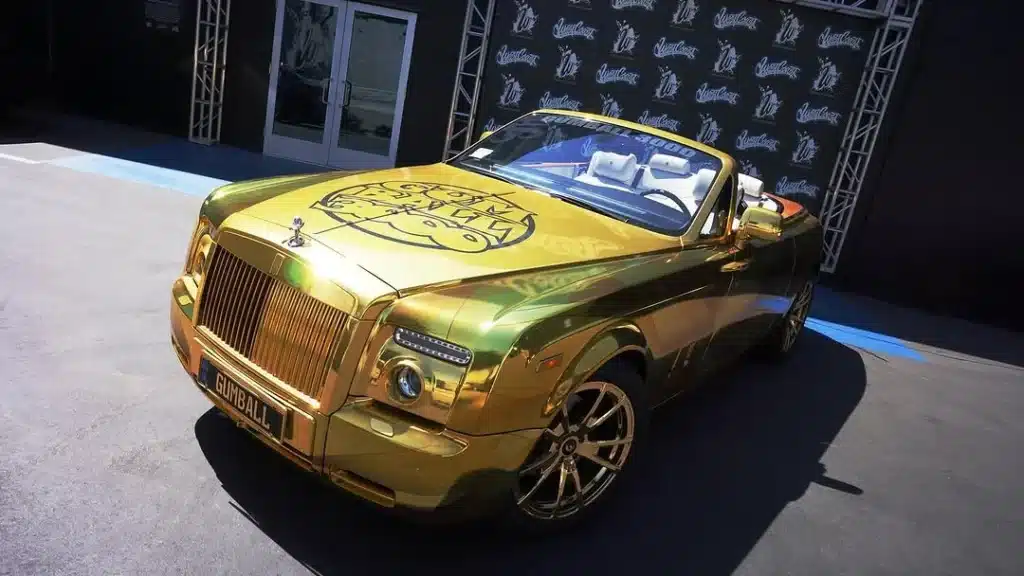 A gold Rolls-Royce Dawn by West Coast Customs will join the Gumball 3000 rally, drawing attention for its bold exterior and V12 performance
