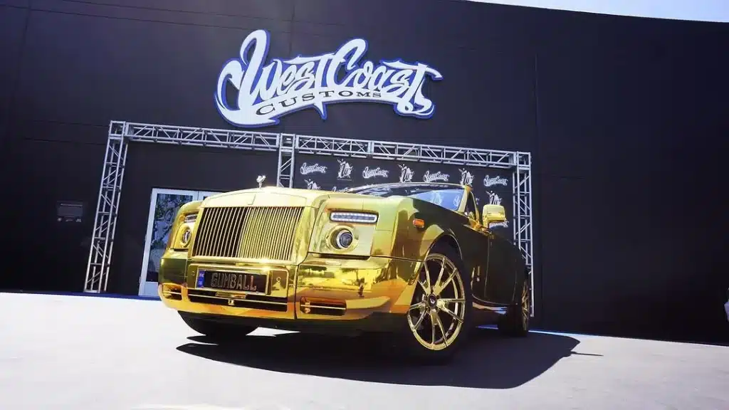 A gold Rolls-Royce Dawn by West Coast Customs will join the Gumball 3000 rally, drawing attention for its bold exterior and V12 performance