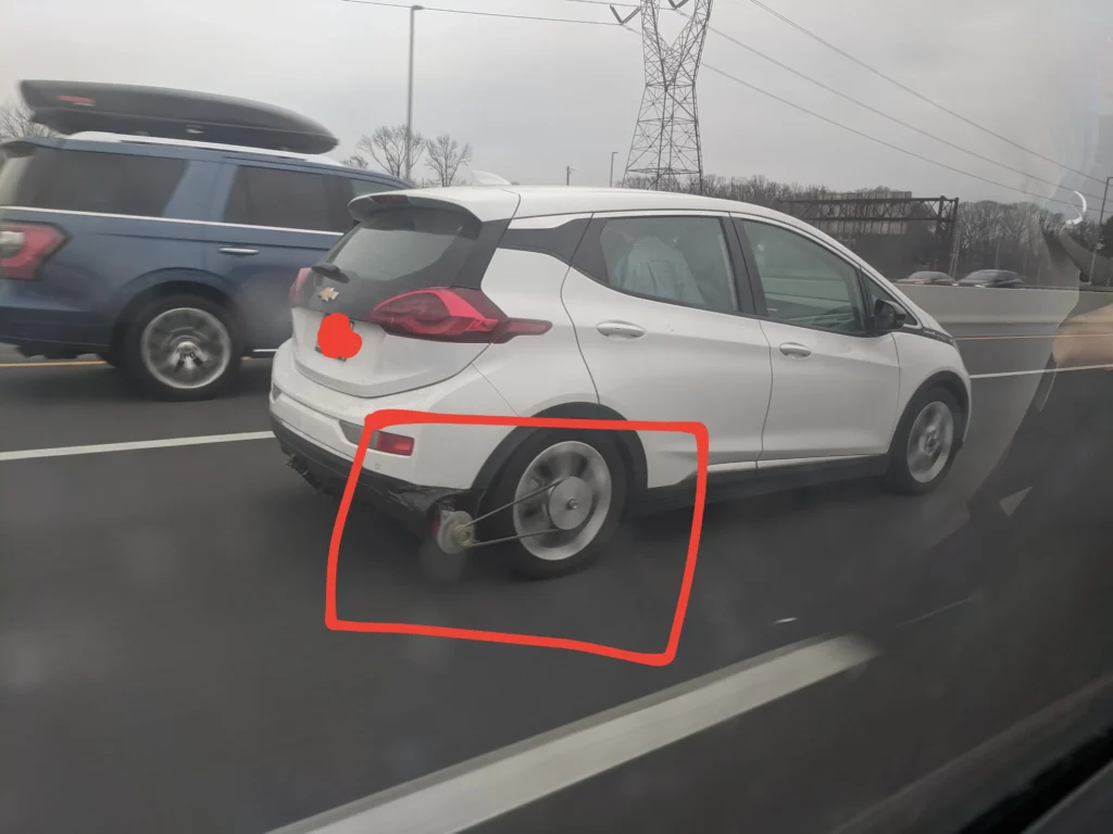 Expert reacts to genius Chevy Bolt driver attaching belt to rear wheel and generator to charge its battery while driving
