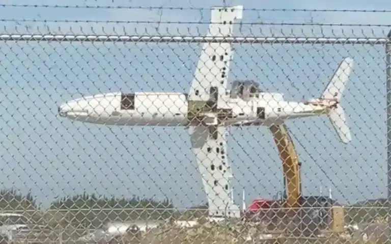 A Florida airport employee at Miami-Opa Locka Executive Airport used the jaw-like grapple of a Cat excavator to grab the mid-section of a plane