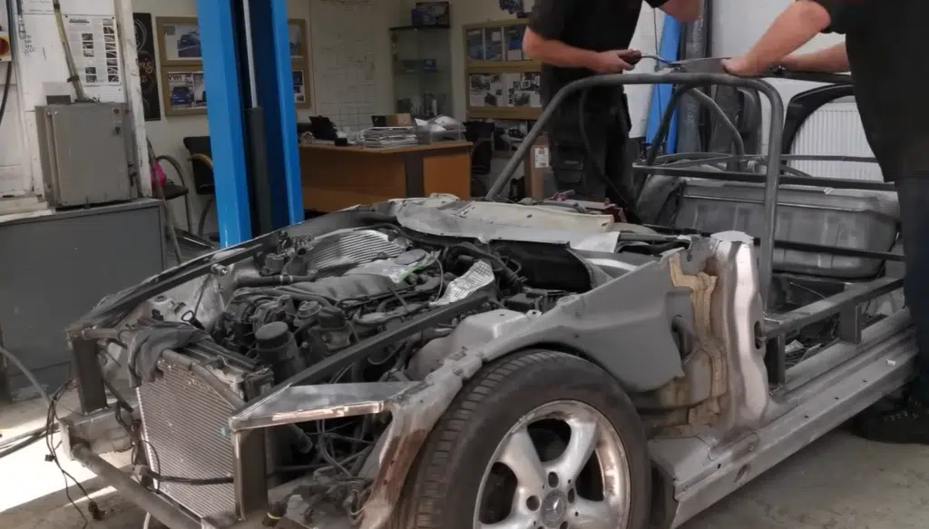 A junkyard Mercedes turned into a replica 300 SL with Gullwing doors using a Mercedes SLK in this restomod project blending style, engineering, and performance