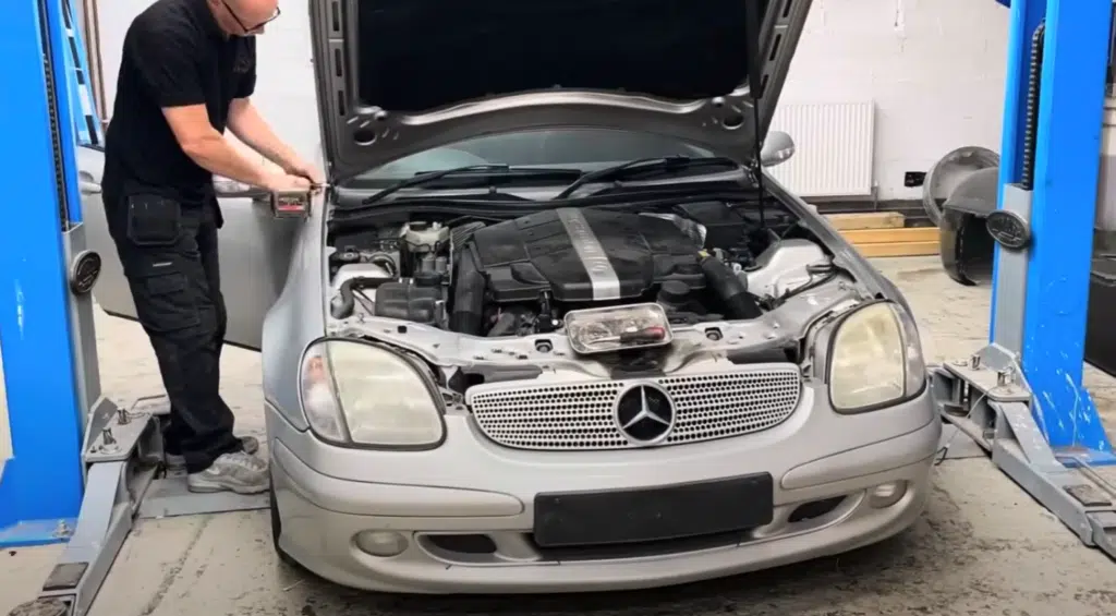 A junkyard Mercedes turned into a replica 300 SL with Gullwing doors using a Mercedes SLK in this restomod project blending style, engineering, and performance