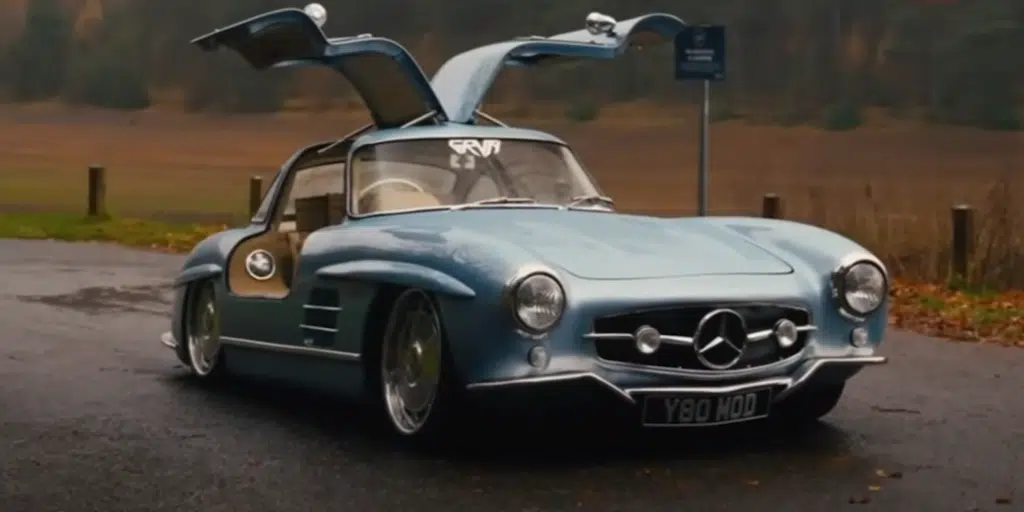 A junkyard Mercedes turned into a replica 300 SL with Gullwing doors using a Mercedes SLK in this restomod project blending style, engineering, and performance