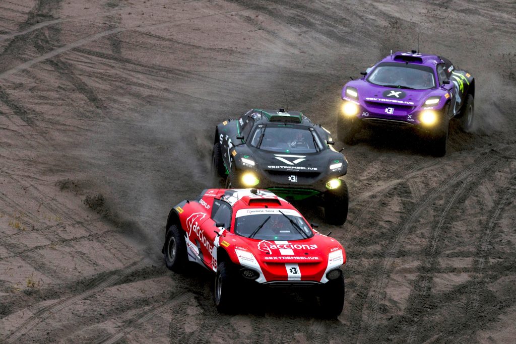 Three cars taking part in Extreme E racing.