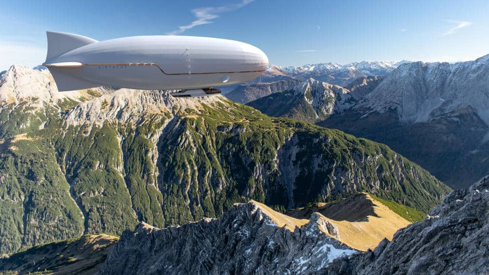 The AirYacht flies over some mountains.