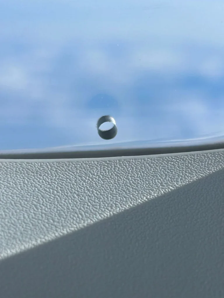 Why does every airplane window have a tiny hole in it?