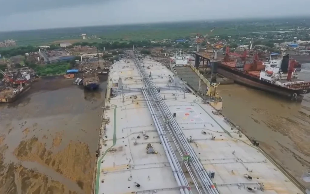 The Alang Ship Breaking Yard in Gujarat, India, is the world's largest ship graveyard, a sprawling coastal zone where the world's retired vessels meet their end.