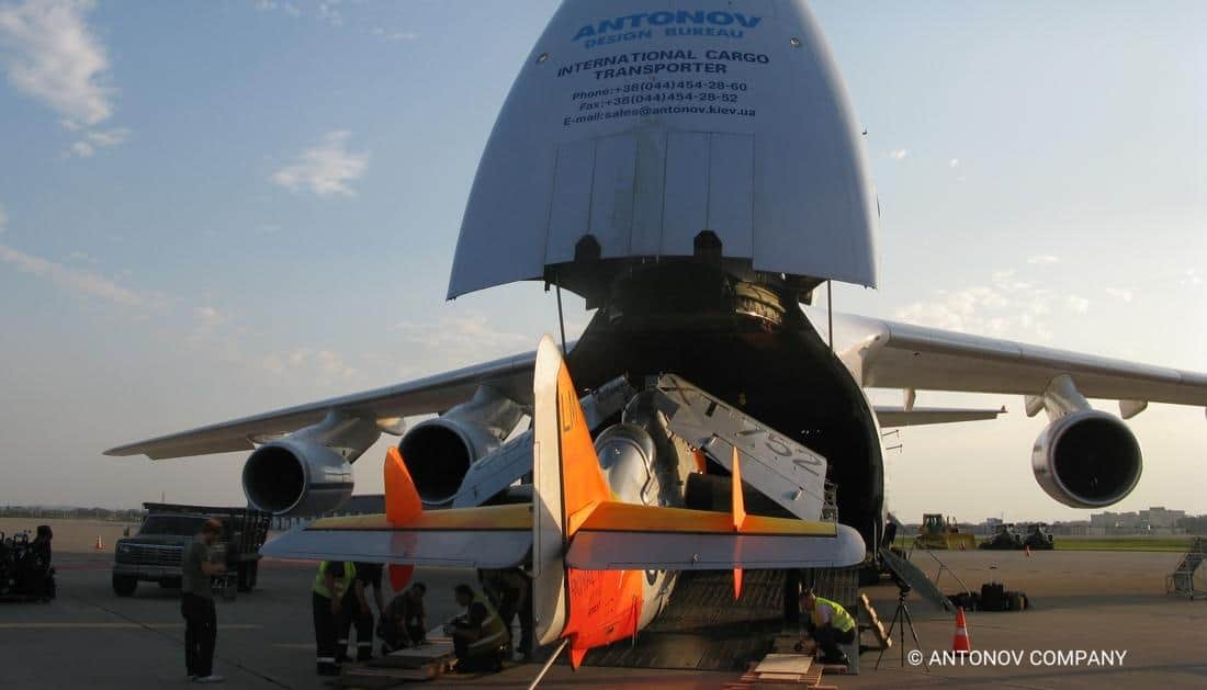 An an-124 being loaded with another plane.