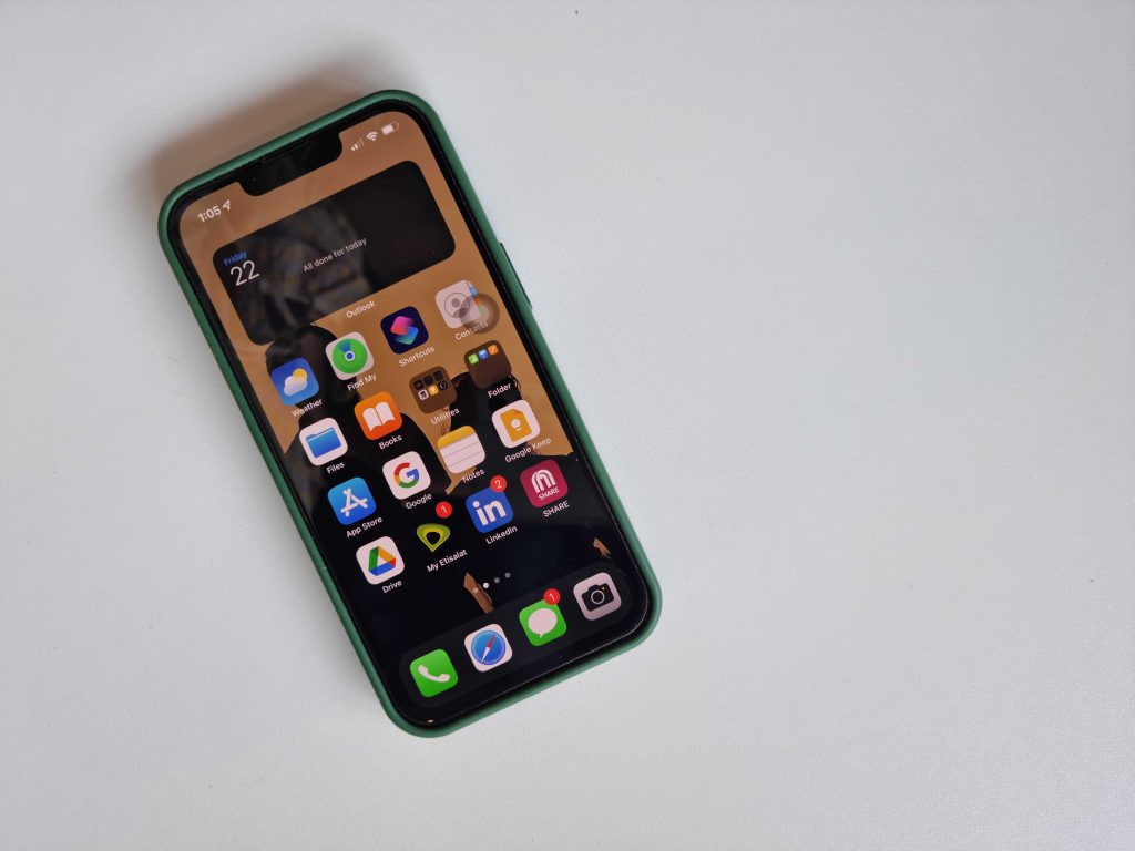 An iPhone with its screen lit up.