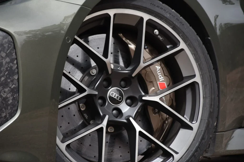 The new Audi RS5 features a steering wheel button for a performance boost from its 630 hp hybrid engine, delivering an incredible and refined driving experience