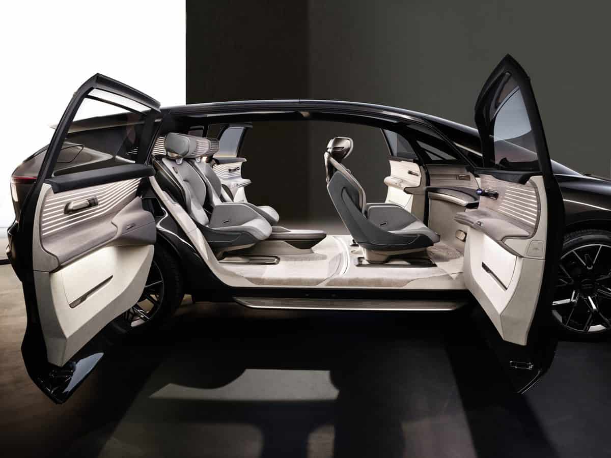 The roomy interior of the Audi urbansphere with doors open and four seats inside.