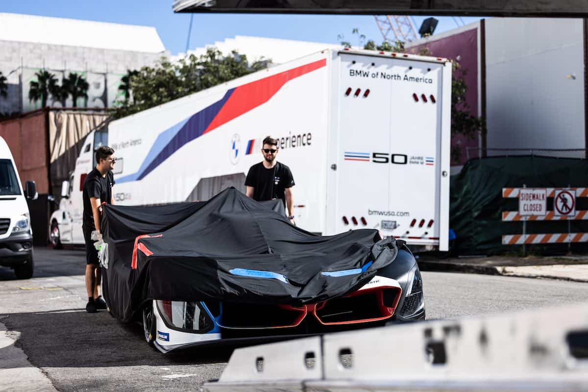 The cover being lifted off the BMW M Hybrid V8 endurance race car