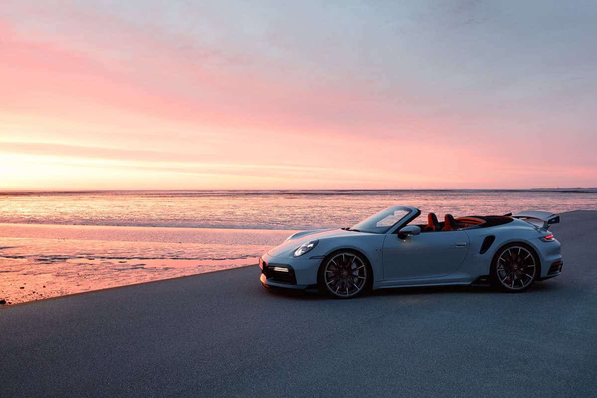 The Porsche overlooks the ocean.