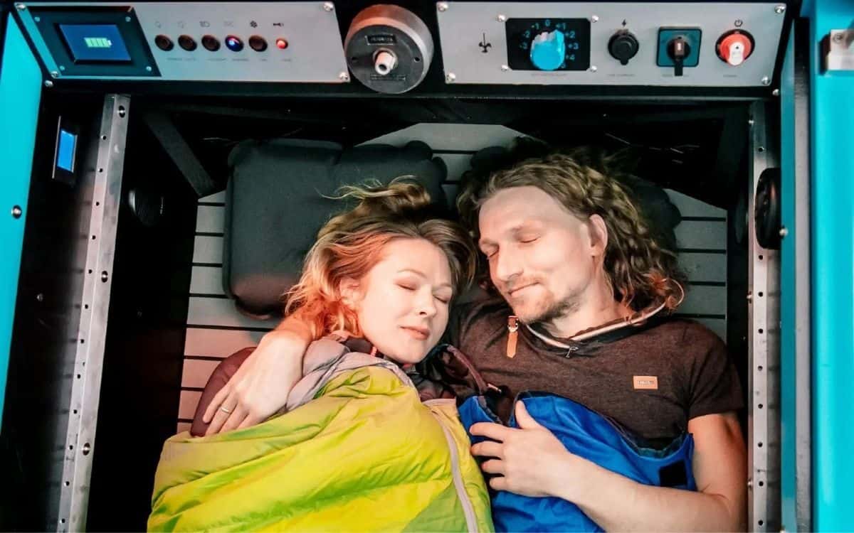 Two people sleep inside the BeTRITON.