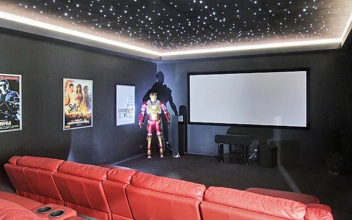 Iron Man stands inside the home theater, one of the bizarre features inside a home.