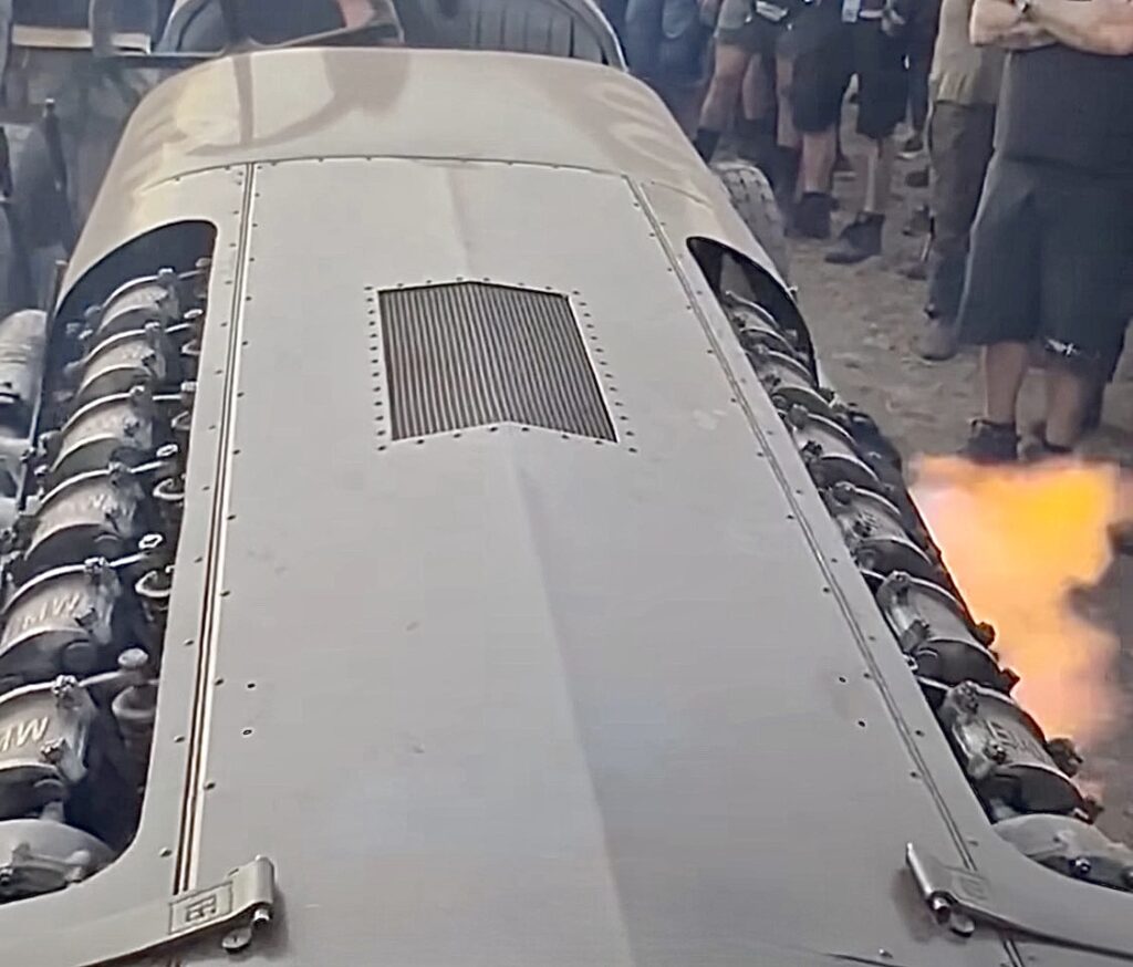 Brutus car, 47-liter car, engine spitting fire, surrounded by crowd