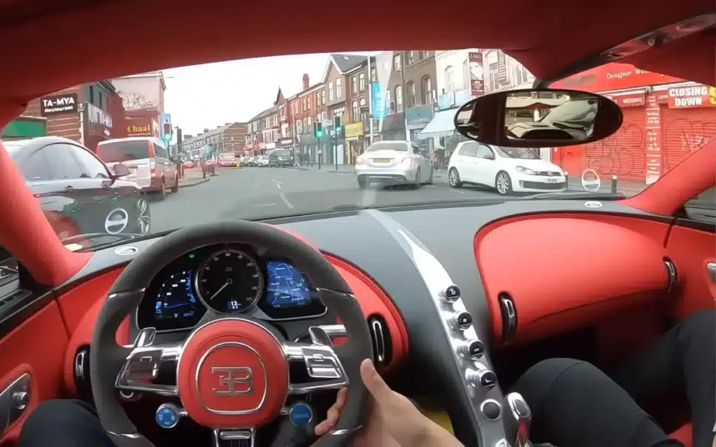 POV drive of a Bugatti Chiron through a city center