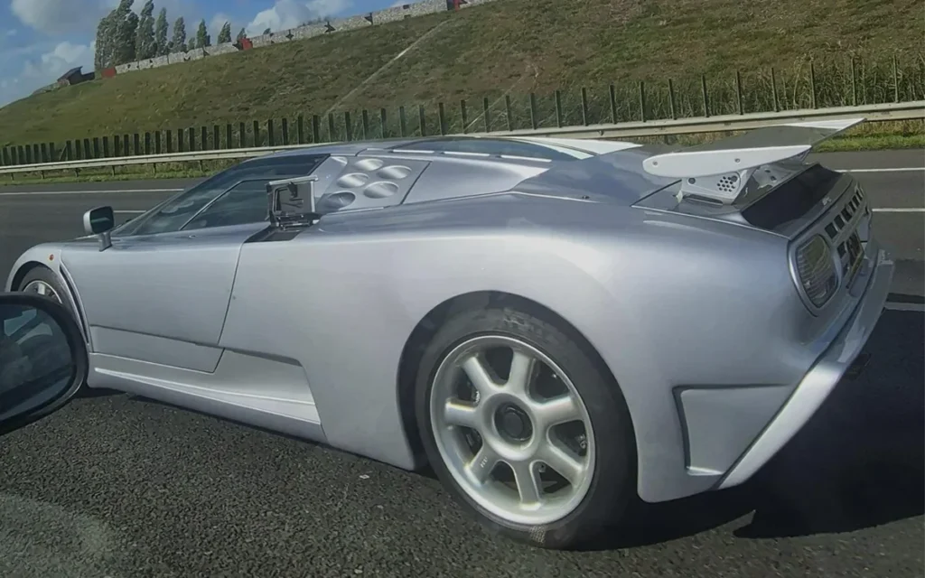 A classic Bugatti EB110 was spotted on a highway in the Netherlands, but one feature left fellow drivers laughing at the rare supercar