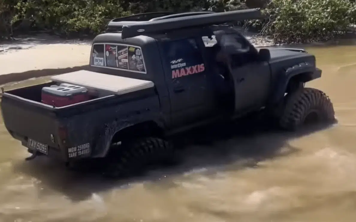 Heavily modified truck attempts water crossing and fails